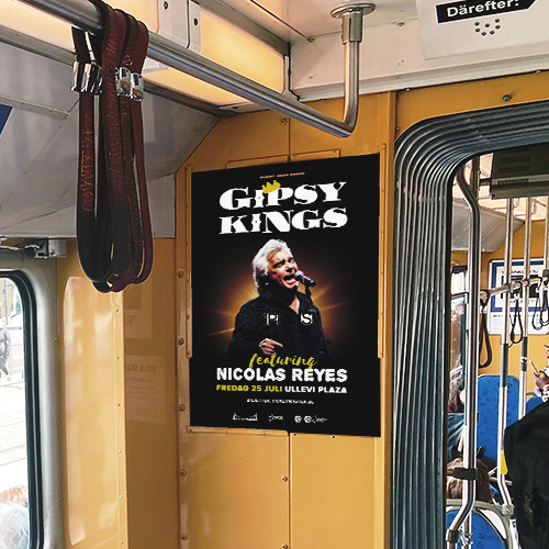 A poster hung in a tram in black and yellow with a picture of an older man singing, promoting the Gipsy Kings concert.