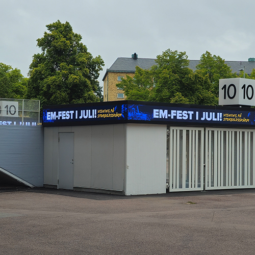 An LED screen outside of Ullevi arena on a cloudy day.